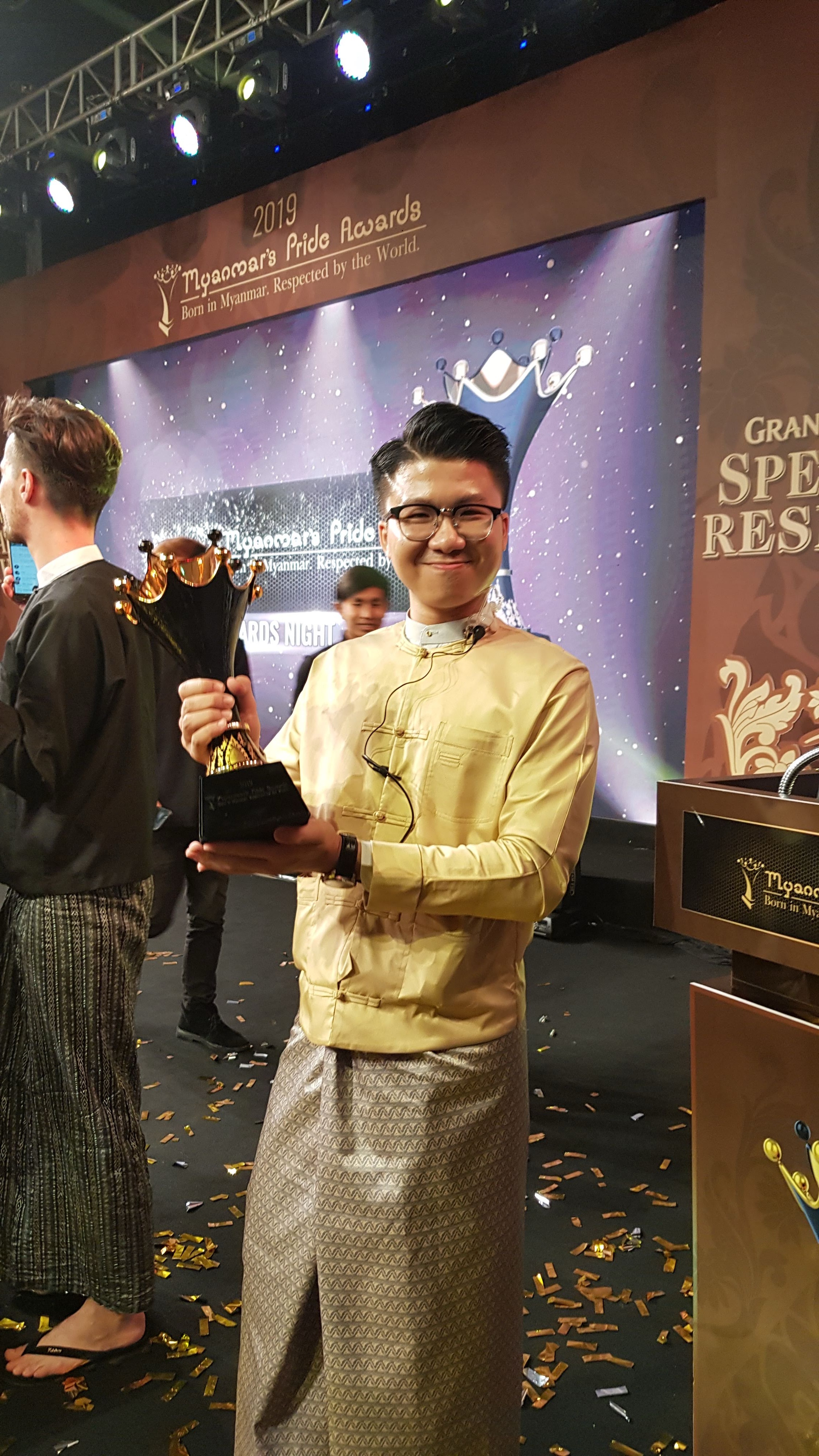 Sai Main holding the trophy at Myanmar's Pride Awards 2019